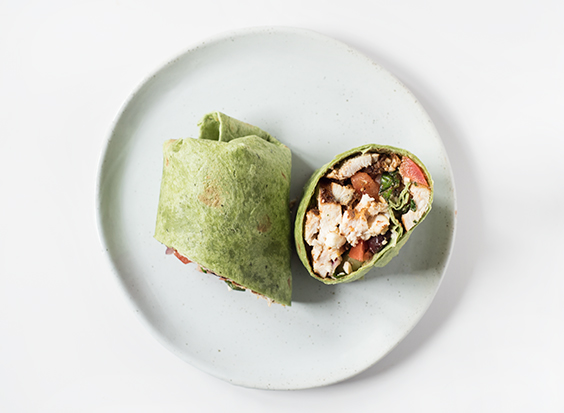 Mediterranean Chicken Wrap - light with crispy veggies, juicy spice-rubbed chicken, all wrapped up in a spinach tortilla. It has so much flavor, you won't even realize you're eating healthy! 