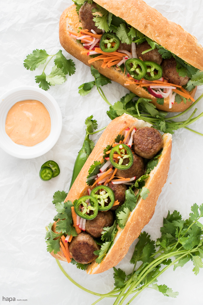 Incredibly moist and flavorful Meatball Bánh Mì Sandwich with fresh veggies and creamy Sriracha mayo on a crispy bun.