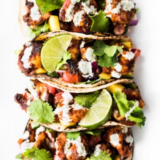 Blackened Shrimp Tacos with Black Bean Mango Salad and Jalapeño Aioli - spicy, tangy, sweet, and completely delicious! Bring an appetite and lots of napkins!