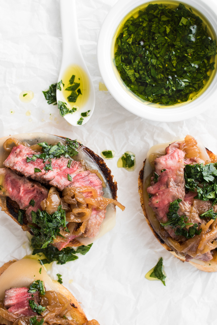 Prepare your taste buds! Tender, juicy steak on crusty garlic bread, with aged provolone cheese, rich caramelized onions, and a drizzle of parsley oil. 