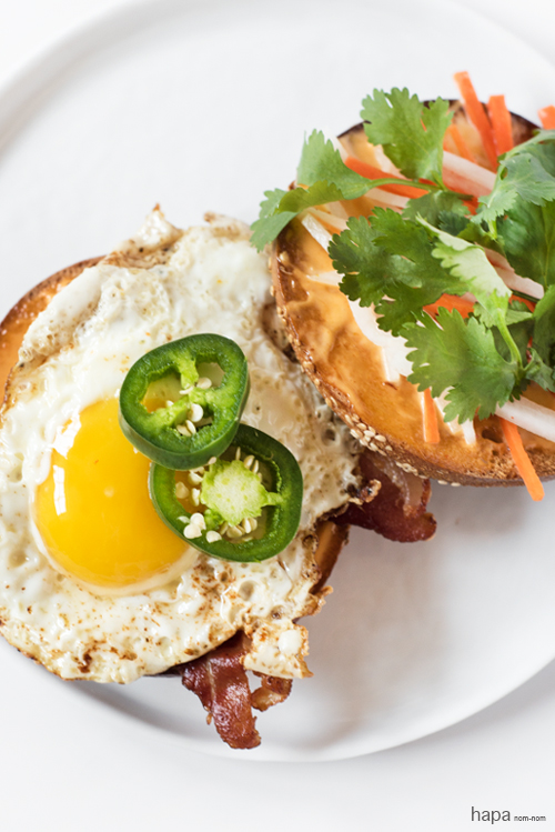 Breakfast-Banh-Mi on a bagel with crispy bacon and fried egg. 