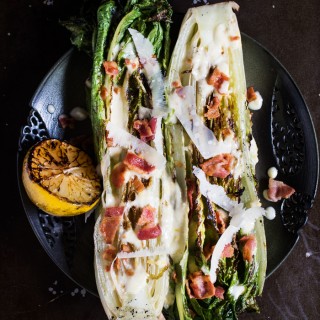 Char grilled romaine hearts, tangy dressing, crispy bacon, and nutty parmesan cheese. You've got to give this Grilled Romaine Lettuce with Creamy Lemon Dressing a try!