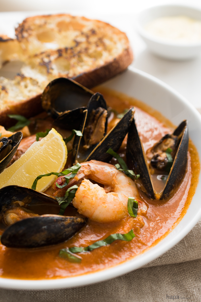 Easy Bouillabaisse - Fresh fish, mussels, clams, and shrimp in a rich broth and served with crusty saffron aioli toast.