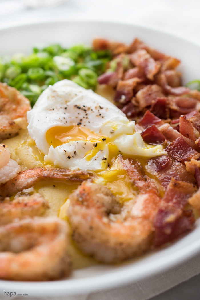 This is a dish that makes a great meal anytime of day! Wether you want a big breakfast, a hearty dinner, or any meal in between; lightly crispy salt & pepper shrimp over cheesy grits, garnished with crispy bacon, scallions, and topped with a creamy poached egg is a dish that will keep you going!