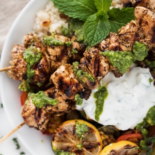 Chicken Souvlaki with Lemon Scented Rice, Roasted Veggies, Creamy Tzatziki, and a Drizzle of Pesto make this full plate flavor experience!
