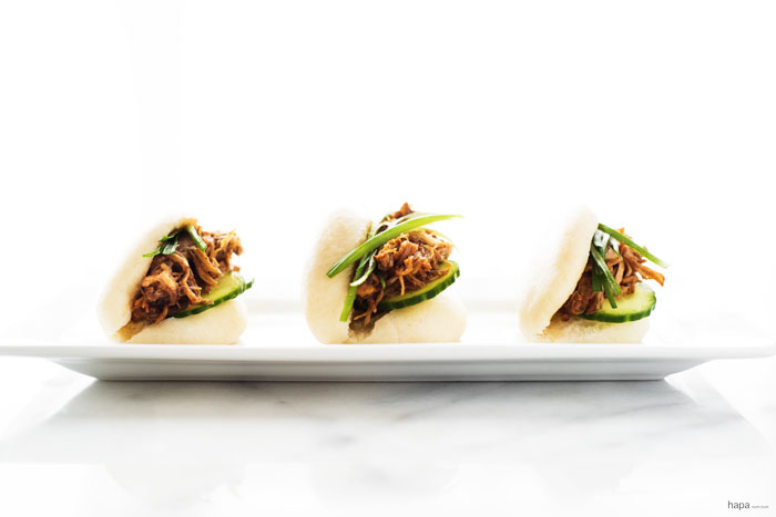 Freshly made steamed buns (gua bao) with pulled pork, dressed with a sriracha bbq sauce, topped with a quick pickle cucumber, and scallions. A...ma...zing!