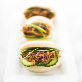 Freshly made steamed buns (gua bao) with pulled pork, dressed with a sriracha bbq sauce, topped with a quick pickle cucumber, and scallions. A...ma...zing!