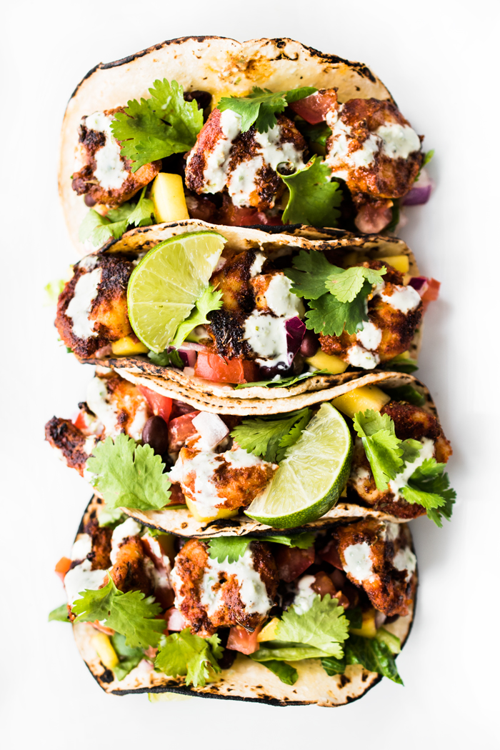 Blackened Shrimp Tacos with Black Bean Mango Salsa and Jalapeño Aioli - spicy, tangy, sweet, and completely delicious! Bring an appetite and lots of napkins! 