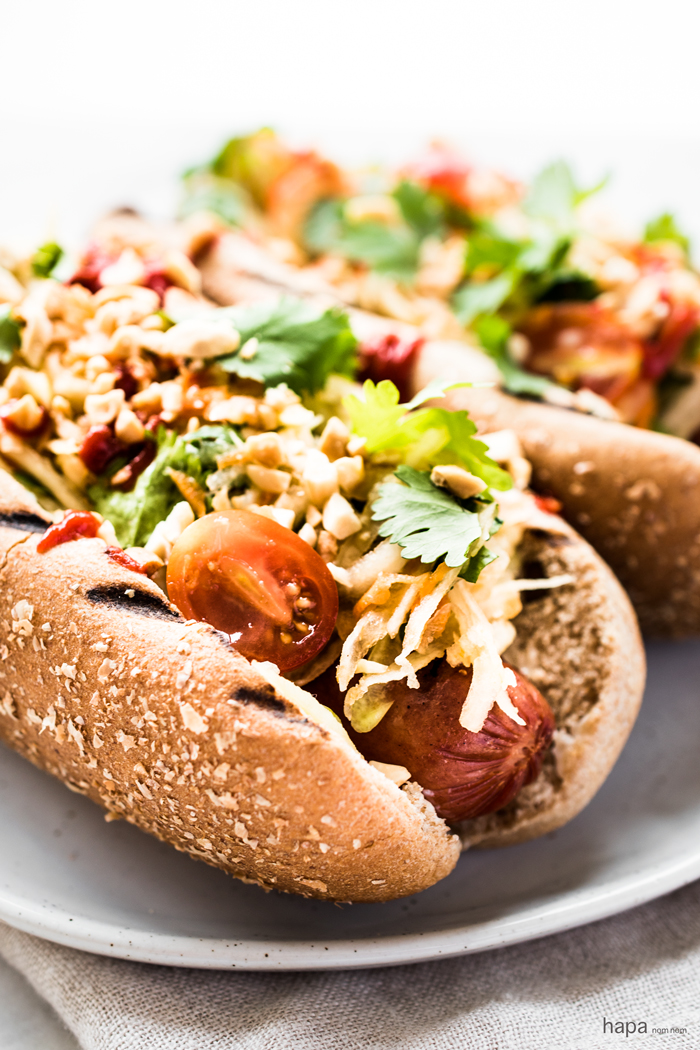 These Thai Style Hot Dogs are a fantastic twist on an American classic - topped with a cool papaya salad, crunchy peanuts, and spicy Sriracha. 