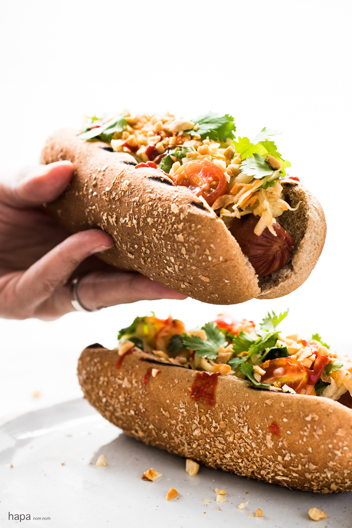 These Thai Style Hot Dogs are a fantastic twist on an American classic - topped with a cool papaya salad, crunchy peanuts, and spicy Sriracha. 