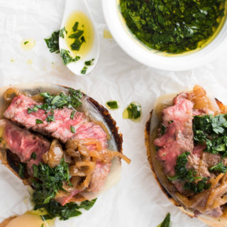 Prepare your taste buds! Tender, juicy steak on crusty garlic bread, with aged provolone cheese, rich caramelized onions, and a drizzle of parsley oil.