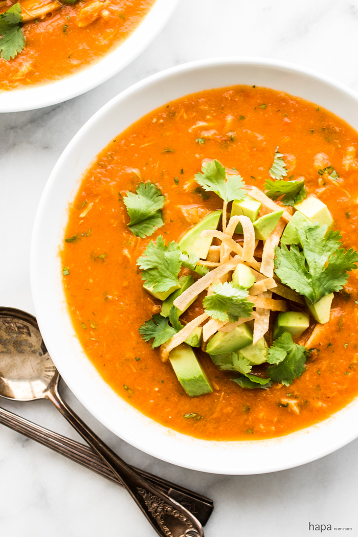 Easy and healthy Chicken Tortilla Soup made with fresh tomatoes and topped with avocado and crispy tortilla strips. 