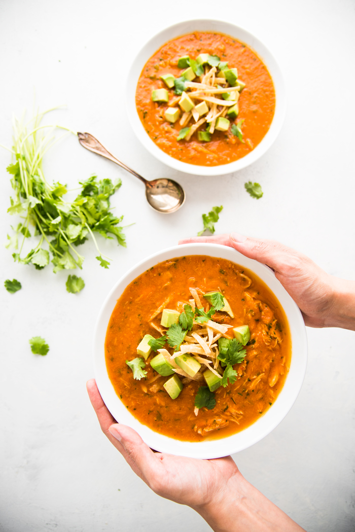 Easy and healthy Chicken Tortilla Soup made with fresh tomatoes and topped with avocado and crispy tortilla strips. 